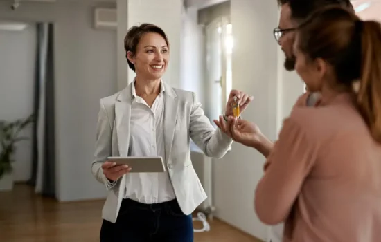 Property manager gives keys to new tenants